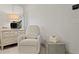 Bedroom featuring chair, lamp, modern dresser, and minimalist decor at 4518 W Rosemere Rd, Tampa, FL 33609