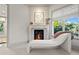 Bright room featuring a fireplace and unique chaise lounge near a window at 4518 W Rosemere Rd, Tampa, FL 33609