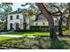 Beautiful home exterior featuring lush landscaping and mature trees on a sunny day at 4518 W Rosemere Rd, Tampa, FL 33609