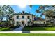 Elegant two-story home with manicured lawn and sophisticated architectural details under a sunny sky at 4518 W Rosemere Rd, Tampa, FL 33609