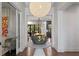 Grand foyer with a statement light fixture, decorative table, and hardwood flooring at 4518 W Rosemere Rd, Tampa, FL 33609