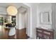Inviting foyer with hardwood floors and an artful table piece beneath a modern light fixture at 4518 W Rosemere Rd, Tampa, FL 33609