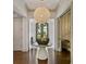 Elegant foyer with a decorative table, pendant lighting, and hardwood flooring at 4518 W Rosemere Rd, Tampa, FL 33609