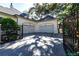 Three car garage with ample parking space on a paved driveway at 4518 W Rosemere Rd, Tampa, FL 33609