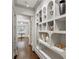 Hallway showcasing unique shelving displaying various vases and other decorative art pieces at 4518 W Rosemere Rd, Tampa, FL 33609