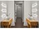 Bright hallway featuring modern lighting, symmetrical decor, and hardwood floors at 4518 W Rosemere Rd, Tampa, FL 33609