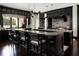 Modern kitchen with a large island, granite countertops, and dark cabinetry at 4518 W Rosemere Rd, Tampa, FL 33609