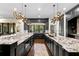 Modern kitchen with granite countertops, dark wood cabinets, modern lighting, and garden view at 4518 W Rosemere Rd, Tampa, FL 33609
