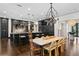 Spacious kitchen featuring dark cabinets, granite countertops, and modern lighting fixtures over the islands at 4518 W Rosemere Rd, Tampa, FL 33609