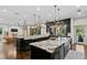 Open kitchen with dual islands, granite countertops, dark cabinets, and high-end appliances at 4518 W Rosemere Rd, Tampa, FL 33609
