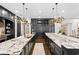 Spacious kitchen boasts dual islands, dark cabinetry, granite countertops, and stylish lighting at 4518 W Rosemere Rd, Tampa, FL 33609