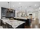 Open kitchen with dual islands, granite countertops, dark cabinets, and high-end appliances at 4518 W Rosemere Rd, Tampa, FL 33609