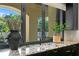 Kitchen sink with granite countertop, black cabinets, and view of the lush outdoor landscape at 4518 W Rosemere Rd, Tampa, FL 33609