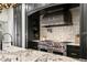 Gourmet kitchen featuring stainless steel appliances, granite countertops, and a designer tile backsplash at 4518 W Rosemere Rd, Tampa, FL 33609