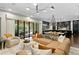 Open floor plan showcases living room and kitchen with large windows and stylish furnishings at 4518 W Rosemere Rd, Tampa, FL 33609