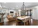 Open-concept living room and dining room with hardwood floors and modern lighting at 4518 W Rosemere Rd, Tampa, FL 33609