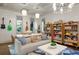 Bright living room with comfortable seating, guitars, and shelving under decorative lighting at 4518 W Rosemere Rd, Tampa, FL 33609