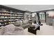 Large living room with custom shelving for shoes/accessories, comfortable seating, and natural light at 4518 W Rosemere Rd, Tampa, FL 33609