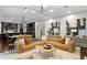 Beautifully designed living room featuring a stylish sectional sofa, modern art, and elegant lighting fixtures at 4518 W Rosemere Rd, Tampa, FL 33609