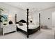 Bright bedroom with modern lighting, white dresser, and stylish decor at 4518 W Rosemere Rd, Tampa, FL 33609