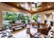 Inviting outdoor living area with stylish furniture, lush landscaping, and covered seating, ideal for relaxation at 4518 W Rosemere Rd, Tampa, FL 33609