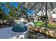 An enticing private pool with a built-in slide and a patio dining area perfect for outdoor relaxation at 4518 W Rosemere Rd, Tampa, FL 33609