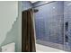 Beautiful blue tiled shower with glass doors, rainfall shower head, and recessed niche at 4518 W Rosemere Rd, Tampa, FL 33609