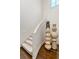 Elegant staircase with wood flooring, carpeted steps, and decorative art pieces at 4518 W Rosemere Rd, Tampa, FL 33609