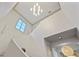 Bright staircase with high ceilings, a modern chandelier, and a window at 4518 W Rosemere Rd, Tampa, FL 33609