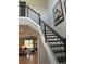 Modern staircase with dark wood treads and metal railing at 4587 Almada Ln, Wesley Chapel, FL 33543