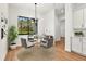 Small dining area with round glass table and four gray chairs at 5738 Landry Ave, North Port, FL 34291