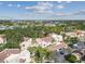Aerial view of a community with Spanish-style buildings, lush landscaping, and a pool at 6101 34Th W St # 29C, Bradenton, FL 34210