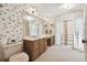 Bathroom with double vanity, large mirror, and floral wallpaper at 6101 34Th W St # 29C, Bradenton, FL 34210