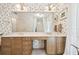 Double vanity bathroom with a large mirror and floral wallpaper at 6101 34Th W St # 29C, Bradenton, FL 34210