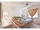 Bedroom with a floral quilt, ceiling fan, and nightstands at 6101 34Th W St # 29C, Bradenton, FL 34210