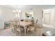 Bright dining room with chandelier and view into kitchen at 6101 34Th W St # 29C, Bradenton, FL 34210