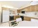 Kitchen with wood cabinets, appliances, and breakfast nook at 6101 34Th W St # 29C, Bradenton, FL 34210