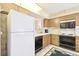 Kitchen with white refrigerator and wood cabinets at 6101 34Th W St # 29C, Bradenton, FL 34210