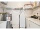 Functional laundry room with washer, dryer, and storage shelves at 6101 34Th W St # 29C, Bradenton, FL 34210