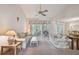 Spacious living room featuring a ceiling fan and access to a patio at 6101 34Th W St # 29C, Bradenton, FL 34210