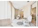 Spacious sunroom featuring white wicker chairs and sheer curtains at 6101 34Th W St # 29C, Bradenton, FL 34210