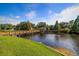 Tranquil lakefront property with a wooden footbridge and gazebo at 6388 93Rd N Ter # 4606, Pinellas Park, FL 33782