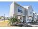 Two-story light gray townhome with landscaping and walkway at 6710 121St Ave # 1, Largo, FL 33773