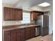 Kitchen with stainless steel appliances and wood cabinets at 734 Climate Dr, Brandon, FL 33511