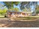 Brick ranch home with large yard and mature trees at 7846 Forbes Rd, Zephyrhills, FL 33540