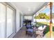 Relaxing covered patio with wicker furniture, ceiling fan, and built-in grill at 8747 Glen Lakes N Blvd, St Petersburg, FL 33702