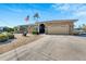 One-story home with stone facade, landscaped yard, and a two-car garage at 925 Golf Island Dr, Apollo Beach, FL 33572