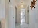 Clean hallway with tile flooring and access to bathroom at 925 Golf Island Dr, Apollo Beach, FL 33572