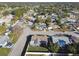 Aerial view of a single Gathering home with a fenced yard and neighborhood in background at 9425 Lido Ln, Port Richey, FL 34668