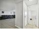 Hallway view of living room with sectional sofa and tile flooring at 9425 Lido Ln, Port Richey, FL 34668